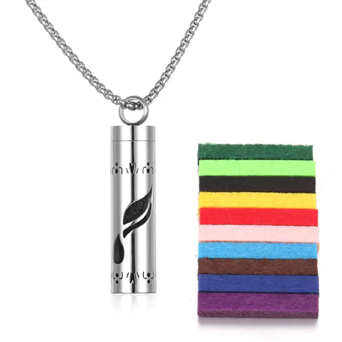 Leaf drop pattern aromatherapy pendant made of stainless steel, includes colorful felt pads for oils.