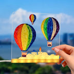 LED acrylic drawing board featuring colorful hot air balloons glowing in sunlight, creating a vibrant light-up art scene for creativity.