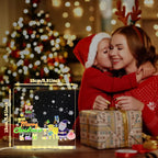 LED acrylic drawing board glowing with Merry Christmas artwork beside a mother and child, creating a festive light-up holiday gift moment.