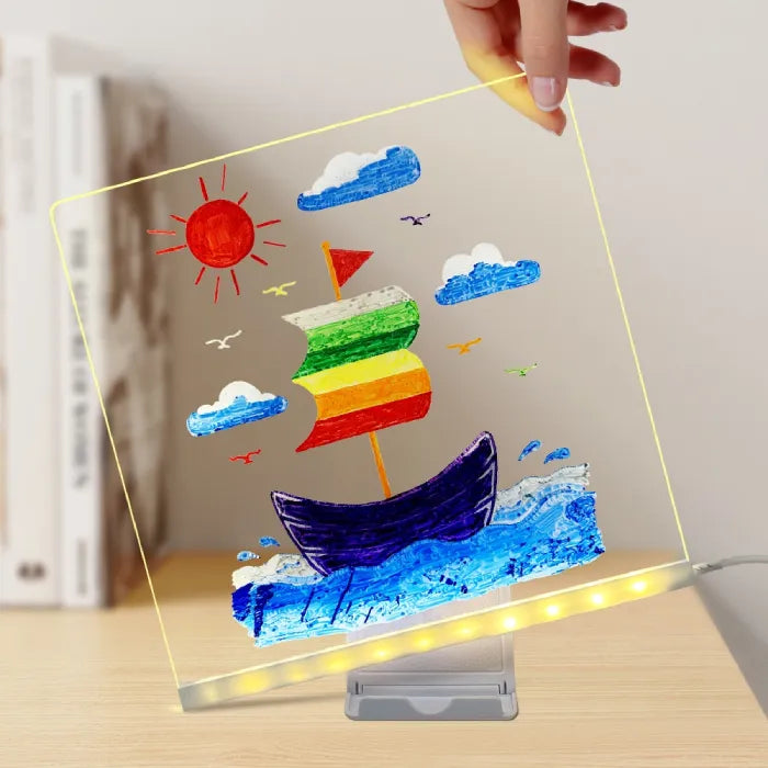 LED acrylic drawing board with vibrant boat drawing under glowing light, showing rainbow sails and ocean waves on a bright creative surface.