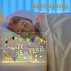 LED acrylic drawing board featuring colorful Happy New Year artwork beside a sleeping child, creating a festive and gentle nightlight effect.