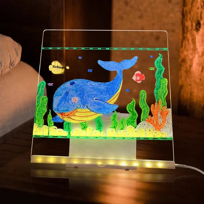 LED acrylic drawing board featuring glowing whale and ocean artwork, creating a bright underwater-themed light-up display for kids.