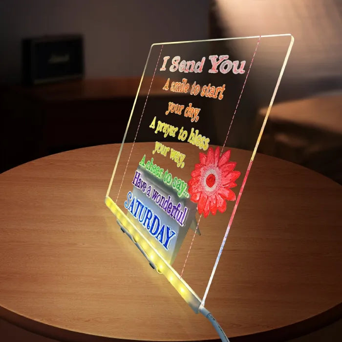 LED acrylic drawing board displaying colorful Saturday greeting with light-up flower design, creating a warm glow message for daily inspiration.