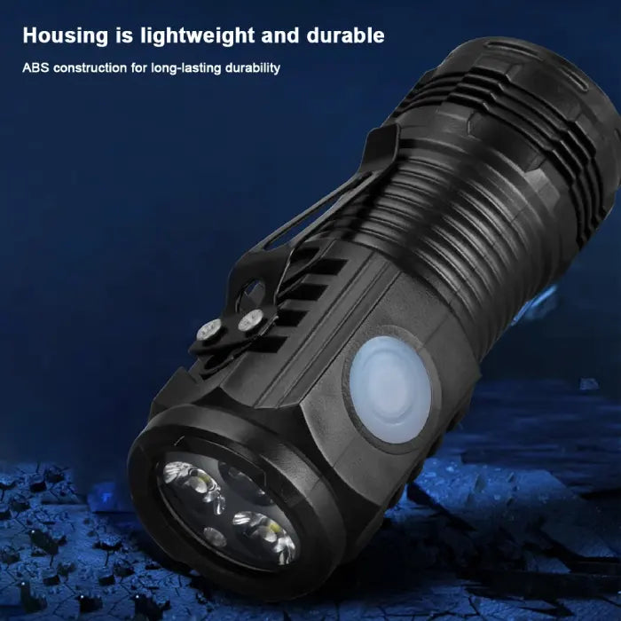 Close-up view of a compact LED flashlight emitting a powerful bright beam.