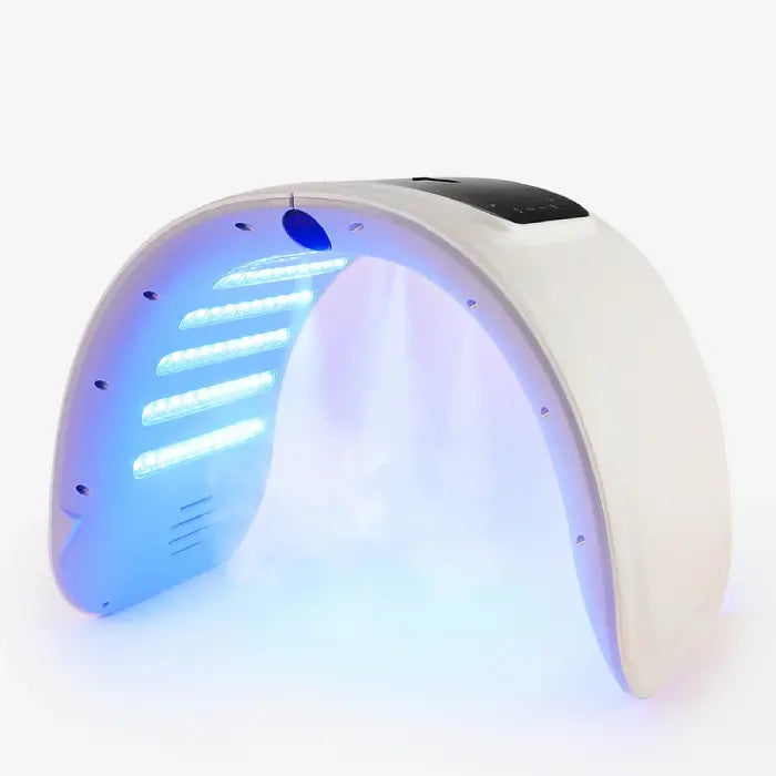 LED light therapy device emitting blue light with visible spray mist underneath.