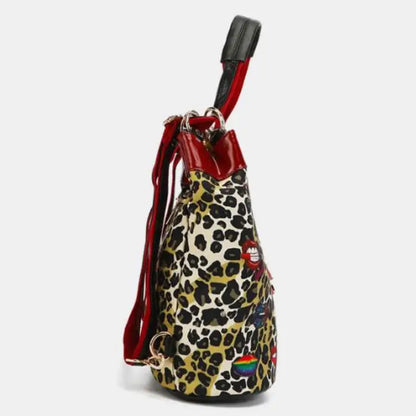 Side profile of leopard print bag with red accents, featuring a sleek and modern fashion design.