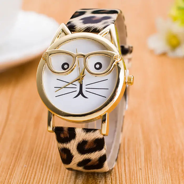 Chic leopard-print strap cat-ear wristwatch featuring a white dial with a fun cat face design and gold details.