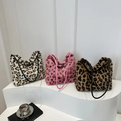 Trio of leopard print faux fur handbags in white, pink, and brown with stylish straps displayed.