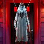 Life size Halloween prop of bloody ghost bride in white dress with skull face hanging at front door.