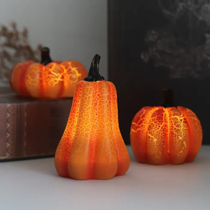 Light up pumpkin decorations set of three arranged indoors with soft orange LED glow