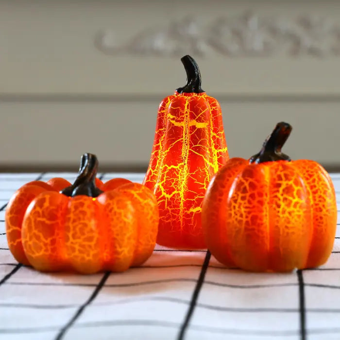 Light up pumpkin decorations arranged on modern white tablecloth for cozy seasonal home decor