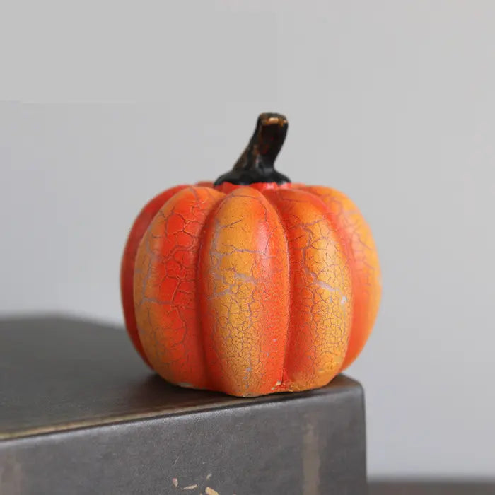 Light up pumpkin decorations in mini orange size with textured crackle pattern and matte black stem