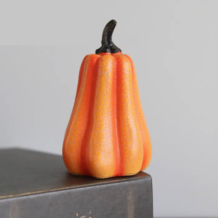 Light up pumpkin decoration shaped like gourd with soft orange crackled surface and curved stem