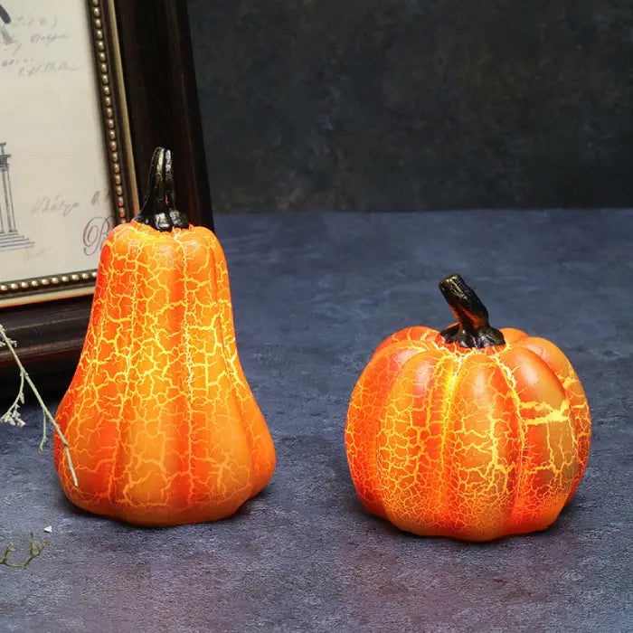 Light up pumpkin decorations on tabletop with glowing crackle finish and rustic stems