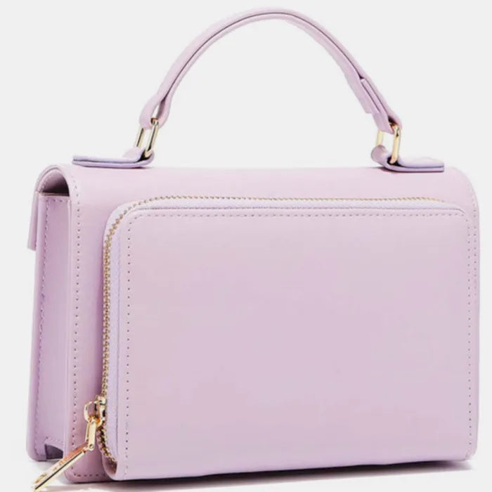 Side profile of lilac leather handbag displaying zipper detail, structured shape, and top handle attachment