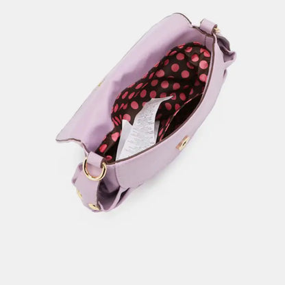  Inside view of purple handbag showing polka dot lining and spacious compartment for everyday essentials storage