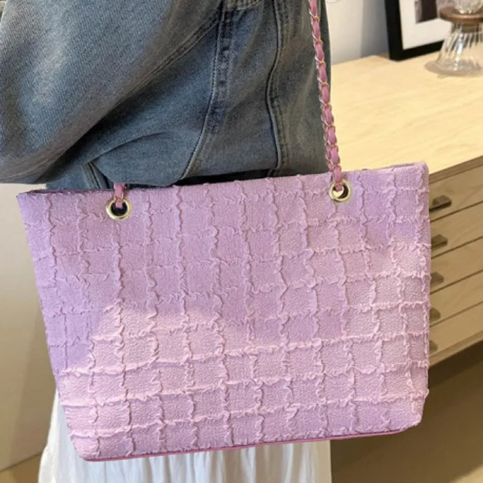 Lilac textured bag with chain strap worn with casual denim outfit