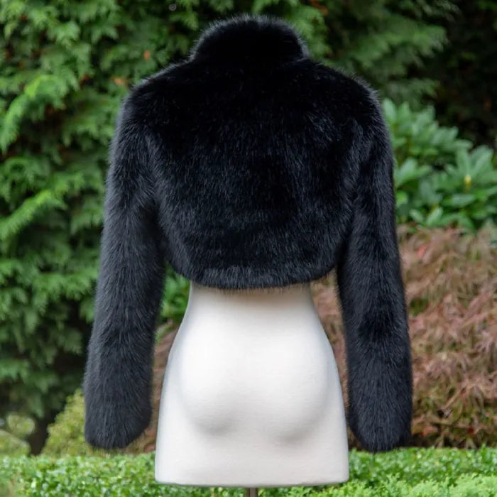 long sleeve faux fur bolero jacket back view in deep black displayed on mannequin, offering a luxe cropped look for evening fashion
