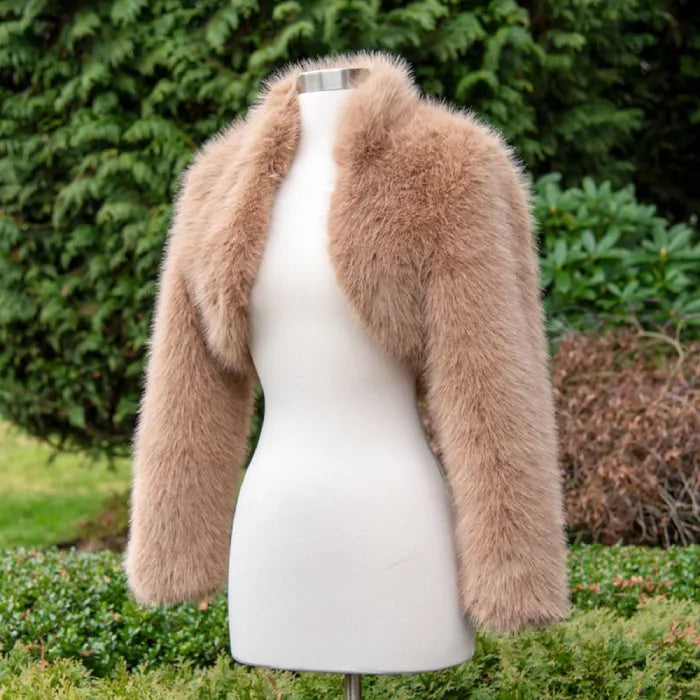 long sleeve faux fur bolero jacket in soft tan displayed on mannequin, showcasing plush texture ideal for elegant wedding or evening wear