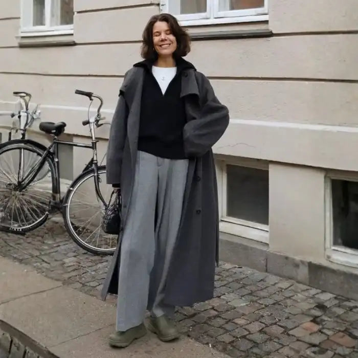 Long tweed coat women in grey worn over wide-leg trousers, featuring an oversized fit for a cozy minimalist winter outfit appeal