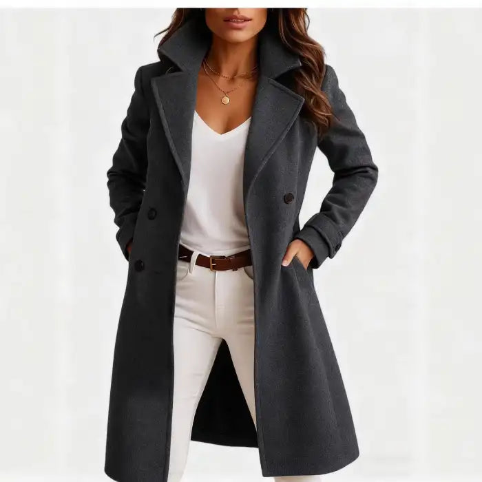 Long wool coat in dark gray with sharp lapel collar, buttoned front, and sleek modern silhouette.