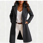 Long wool coat in dark gray with sharp lapel collar, buttoned front, and sleek modern silhouette.