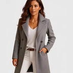Long wool coat in light gray featuring classic tailoring, notch lapel, and soft winter fabric.