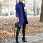 longline coat women in bright blue styling a fall outfit with coffee and handbag