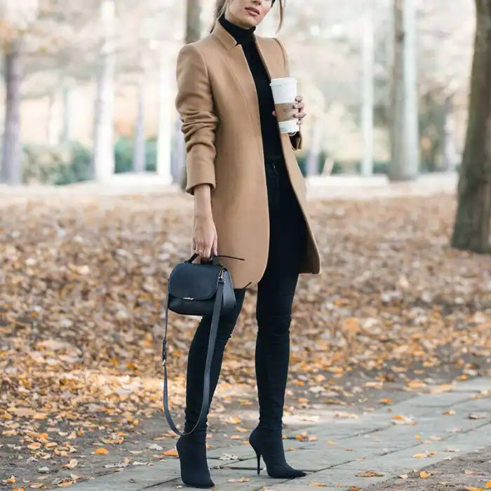 longline coat women in camel color styled with black pants and boots outdoors