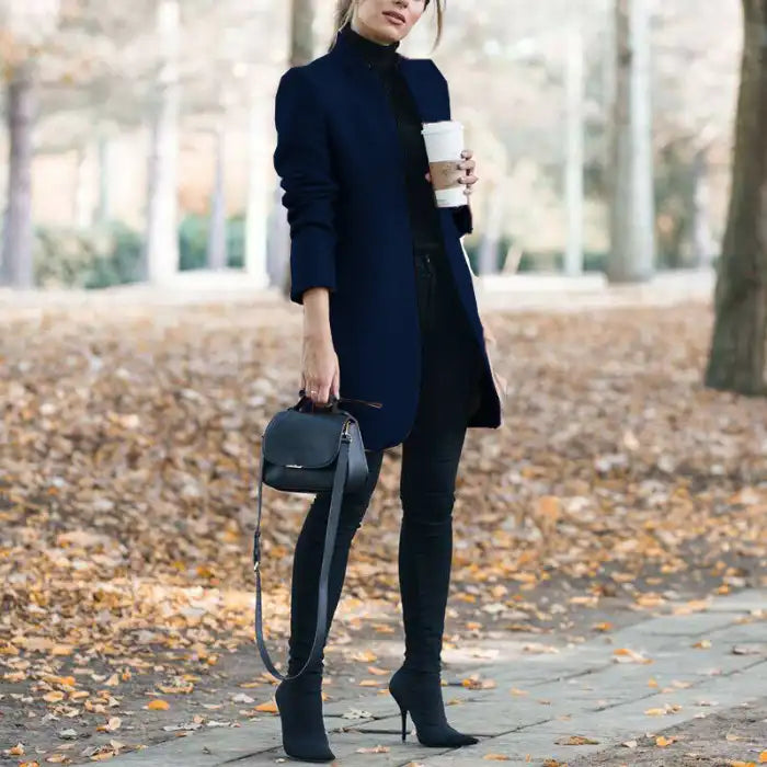 longline coat women in navy blue paired with black jeans and boots in fall