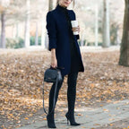 longline coat women in navy blue paired with black jeans and boots in fall