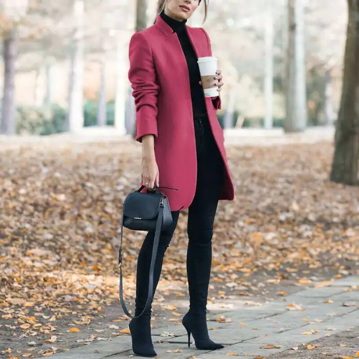 longline coat women in rose pink standing on a fall path holding coffee and handbag