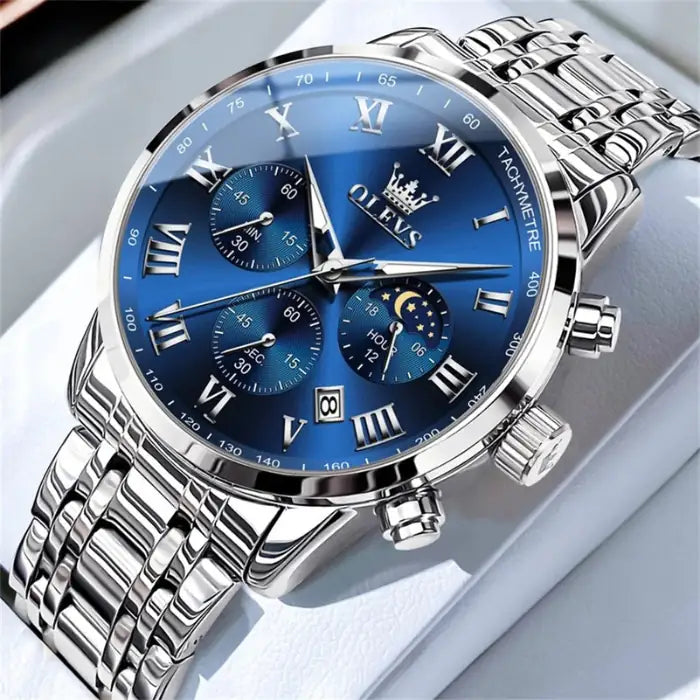 luminous stainless steel watch with blue dial, gold accents and chronograph features displayed elegantly in luxury presentation setting