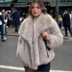 Luxury faux fur coat in beige worn by model on city street, showcasing plush oversized collar and soft fluffy fibers for chic winter fashion