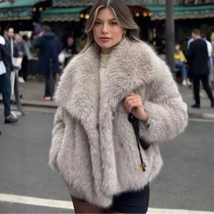 Luxury faux fur coat in beige worn by model on city street, showcasing plush oversized collar and soft fluffy fibers for chic winter fashion