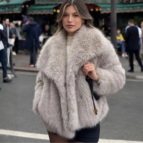 Luxury faux fur coat in beige worn by model on city street, showcasing plush oversized collar and soft fluffy fibers for chic winter fashion