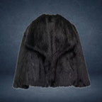 Luxury faux fur coat in deep black displayed on dark backdrop, featuring voluminous plush fibers for bold high-end winter elegance
