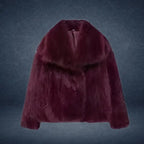 Luxury faux fur coat in deep burgundy with wide collar displayed on dark backdrop, offering refined rich texture for elegant winter wear