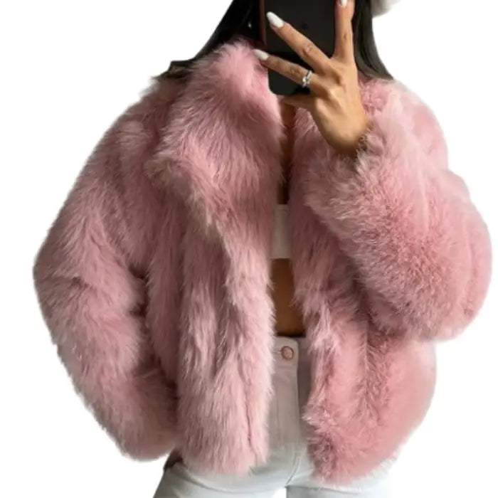 Luxury faux fur coat in pink worn by model, showcasing soft voluminous fibers and stylish cropped fit ideal for trendy winter looks
