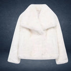 Luxury faux fur coat in white shown on dark backdrop, featuring plush thick fibers and wide collar for premium warm winter outerwear