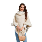 Luxury Fur-Trimmed Knit Poncho paired with neutral handbag, featuring soft fur edging and elegant knit design for chic cold-weather style