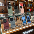Luxury suede phone cover collection displayed on stands in multiple colors, showing premium textured cases designed for stylish protection.