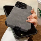 Luxury suede phone cover in grey placed over another phone, highlighting its premium suede case texture and strong dual-layer protection.