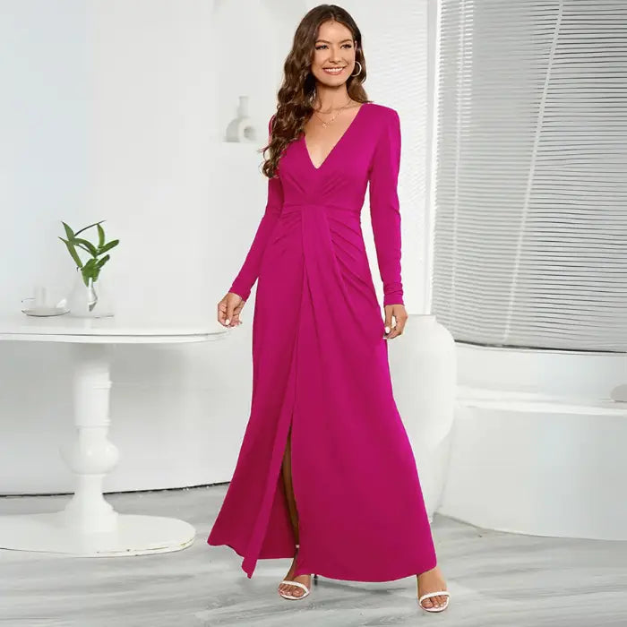 Magenta long sleeve V-neck maxi dress with a front slit and ruched waist detail.