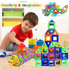 Boy in red shirt playing with magnetic building blocks, building colorful rocket and pyramid shapes.