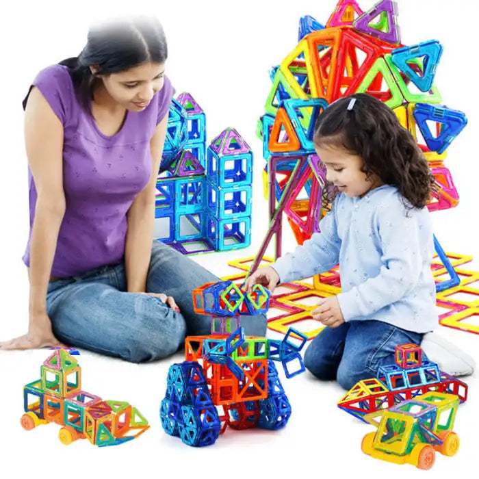 Mother and daughter bonding while building cars and towers with colorful magnetic building blocks.