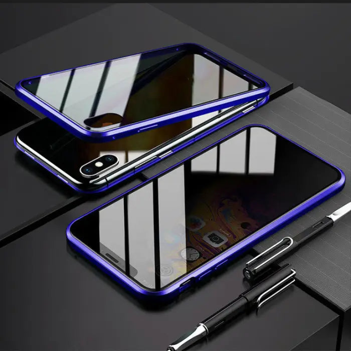 Shockproof magnetic iPhone case with a blue frame and glowing accents on a modern desk.