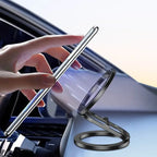 Magnetic phone holder mounted in car with hand placing phone near magnetic ring for attachment.