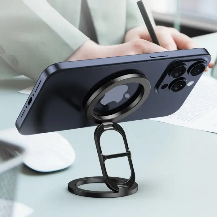 Magnetic phone holder used as desk stand for hands-free viewing while writing or working.