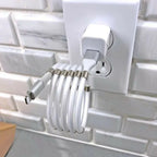 magnetic self coiling usb c charging cable shown forming tight loops beside laptop and phone for stable and tidy charging layout